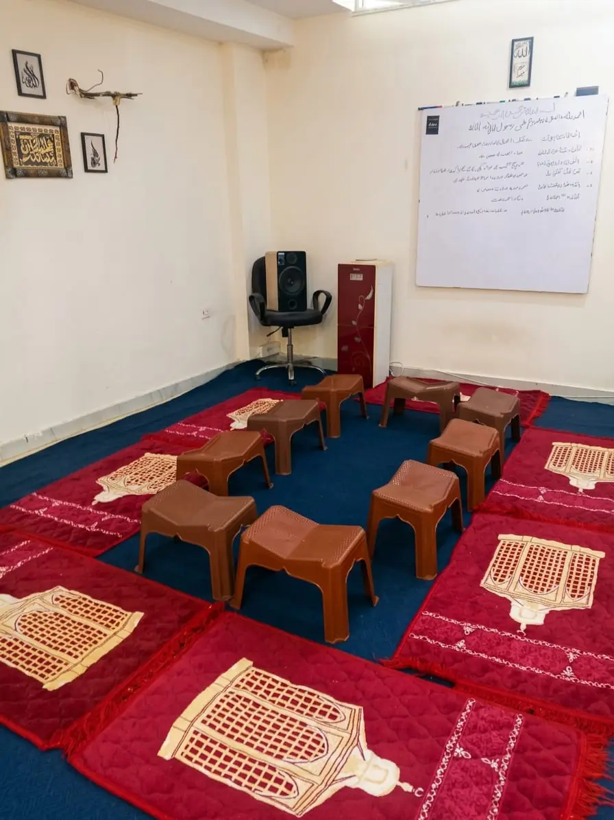 Quran classroom with mats and stands at Dar Al Isar, Bahria Town Lahore