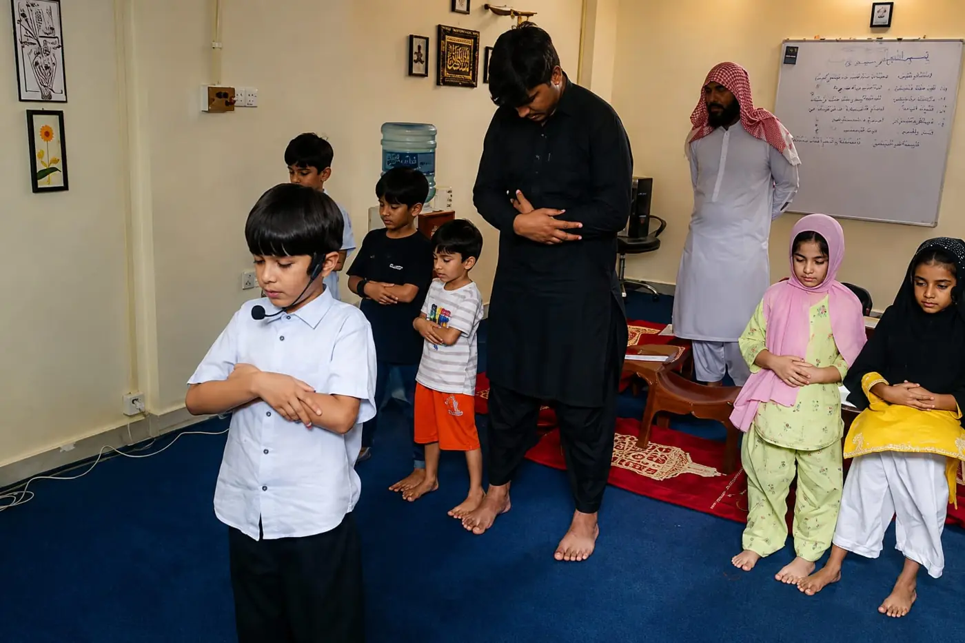 Boys, girls and teachers during Salah practice
